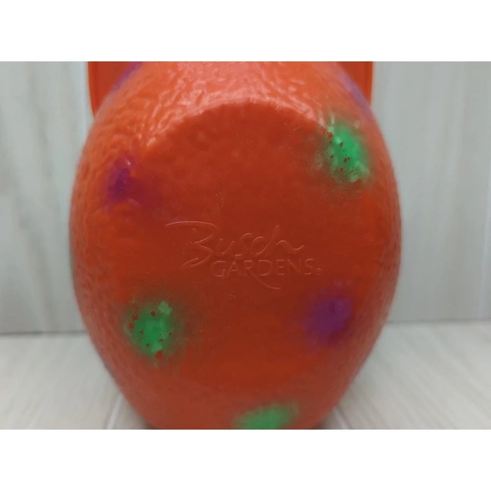 Busch Gardens Land of the Dragons orange egg carry case green baby dragon
